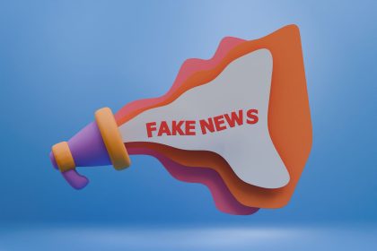 Ilustração 3D de um megafone colorido com a expressão “Fake News”, simbolizando a desinformação nos meios digitais.